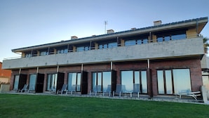 A two-story building with large windows and a flat roof. - La Venta Del Mar (Pielagos)