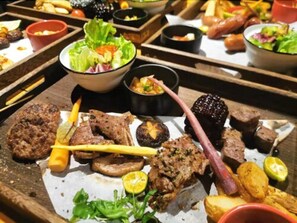 A variety of meats and sides on a wooden serving tray. - Moju Hotel Shanghai (Shanghai)
