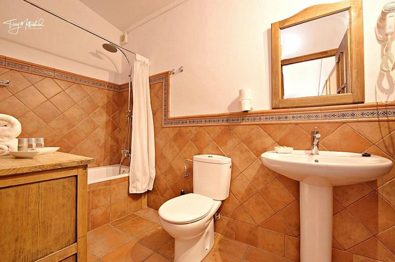 A bathroom with a bathtub, toilet, and sink.