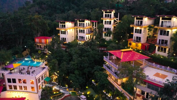 A resort with multiple buildings, a swimming pool, and well-lit pathways. - Veda5 Ayurveda And Yoga Retreat (Yamkeshwar)