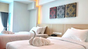 A hotel room with two beds, a headboard, and three wall art pieces. - Sann Hotel (Chiang Rai)