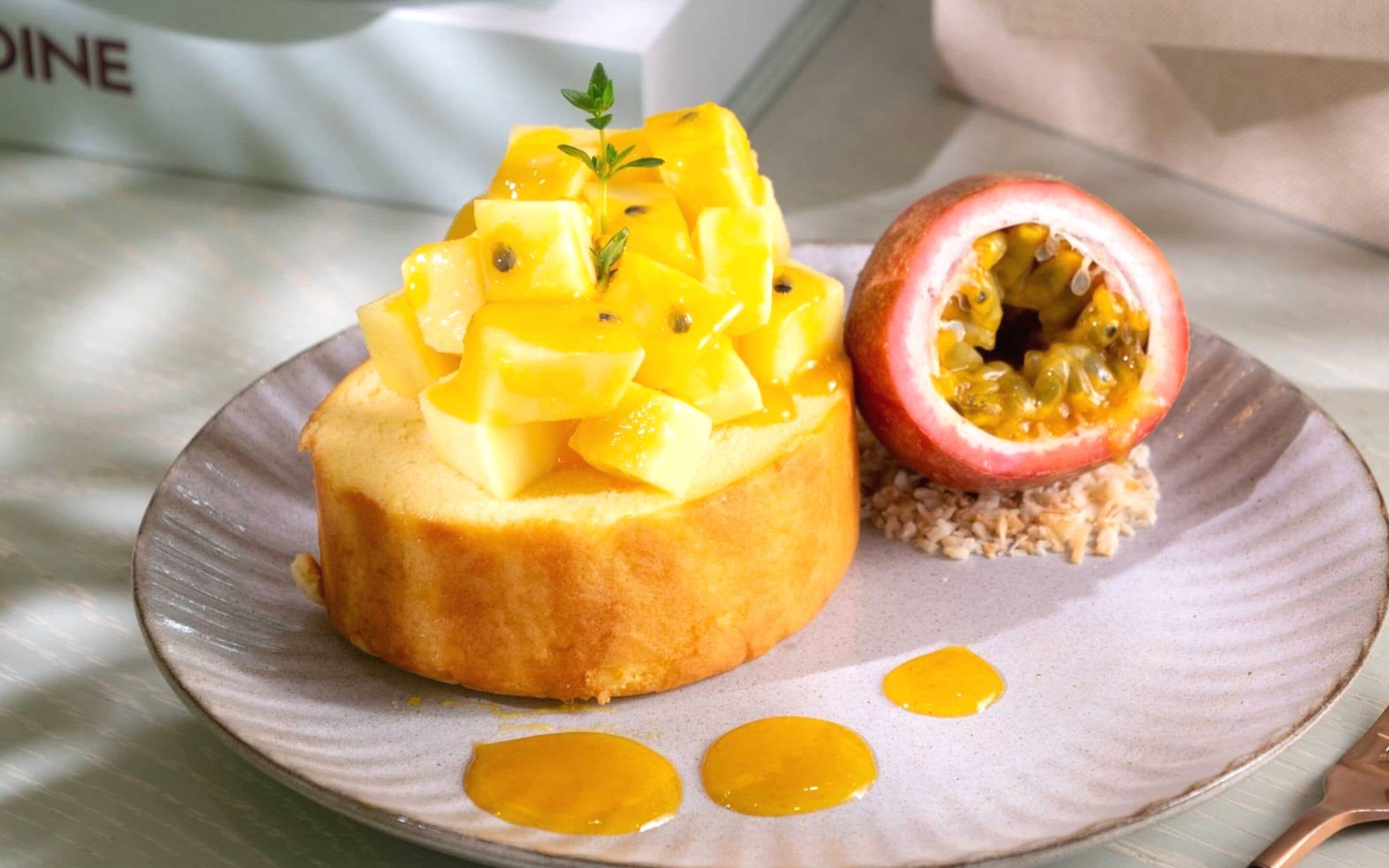 A dessert with mango and passion fruit on a plate.