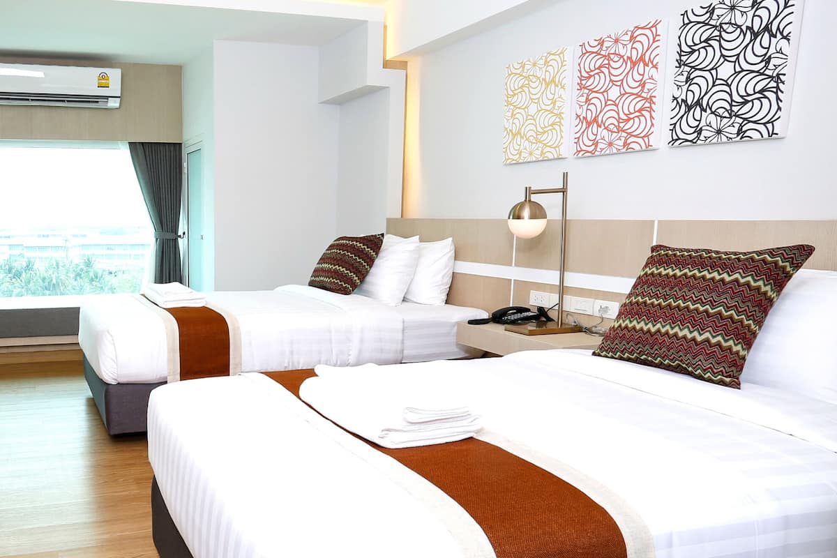 deluxe twin room | in-room safe, desk, laptop workspace, blackout curtains