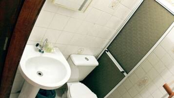 A bathroom with a sink, toilet, and shower.