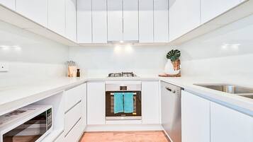 Deluxe Apartment, 2 Bedrooms | Private kitchen | Fridge, microwave, oven, stovetop