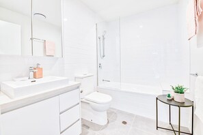 Deluxe Apartment, 2 Bedrooms | Bathroom | Combined shower/tub, deep soaking tub, free toiletries, hair dryer