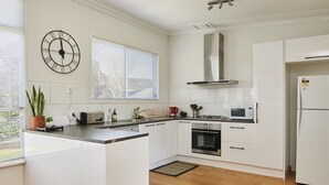 Apartamento premium, 2 quartos | Cozinha privada | Geladeira, micro-ondas, fogão, cooktop