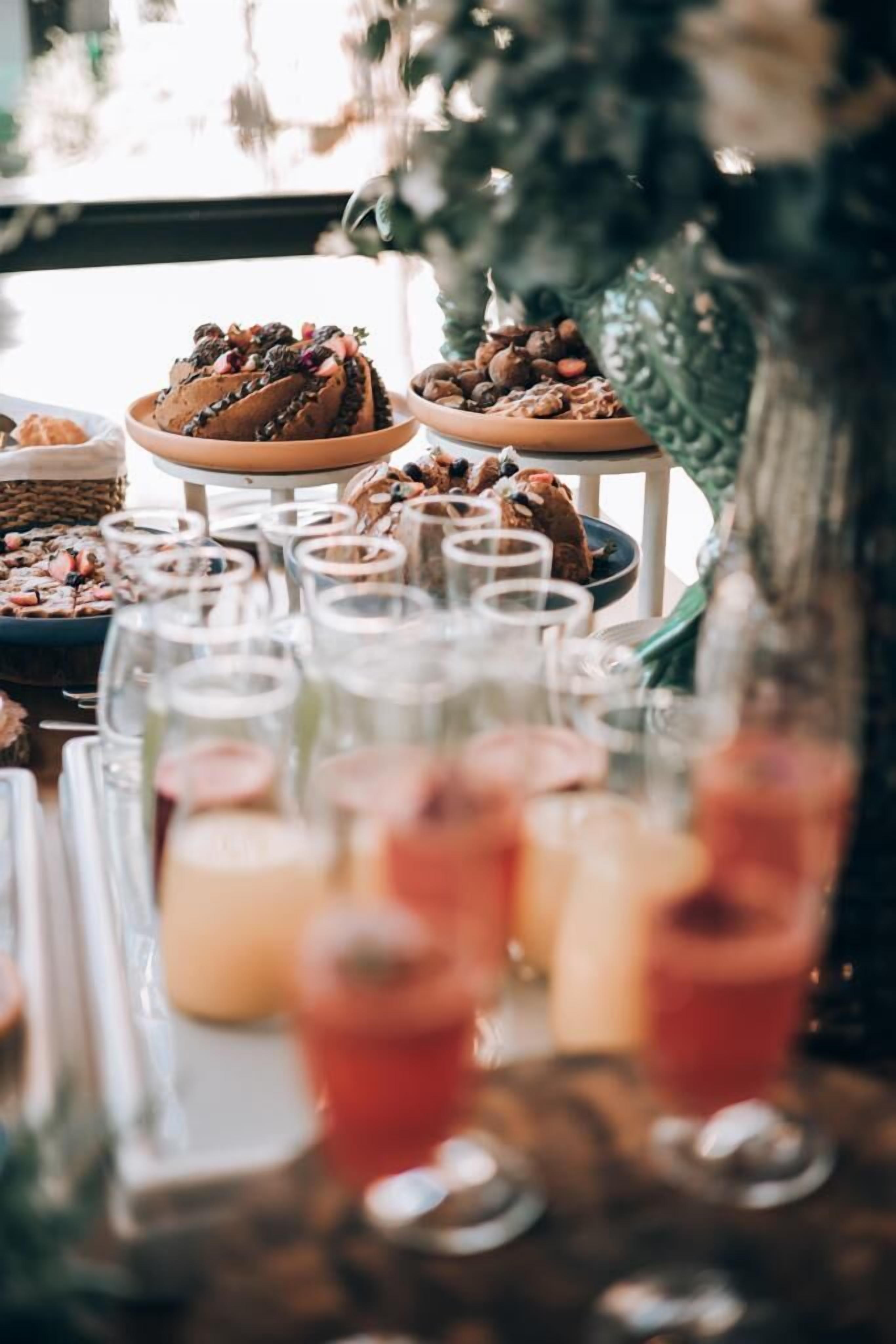 A buffet table with various dishes and drinks.