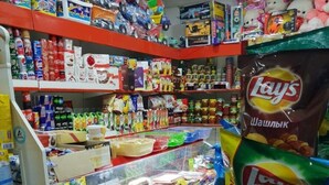 A convenience store with shelves stocked with snacks, drinks, and toys. - Hotel Khiva (Tashkent)
