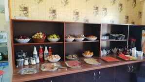 A buffet setup with various food items and condiments. - Hotel Khiva (Tashkent)