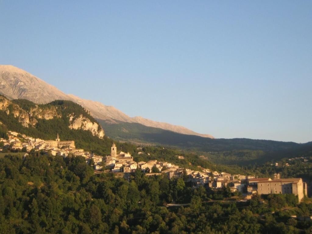 A town nestled in a valley with a prominent church and castle-like building.