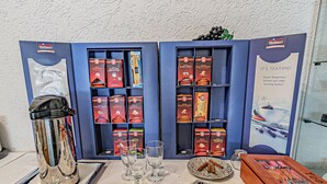 Een ontbijtarrangement met een koffieapparaat, glazen en diverse ontbijtboxen.
