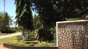 A stone wall with a sign for Panori Hotel. - Panori Hotel (Tanga)