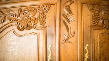 Un panel de madera con elaboradas tallas de hojas, uvas y un pájaro.