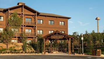 A multi-story hotel with a wooden facade, a balcony on the second floor, and a sign reading "Hotel Colorado Creek."