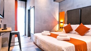 A modern hotel room with a large bed, a desk, and a chair. - J24 Hotel Milano (Milan)