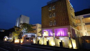 A hotel with a modern facade, a prominent entrance with illuminated signage, and a well-lit exterior. - Fine Misaki Minami Ichibanchi (Misaki)