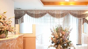 A luxurious bathroom with marble countertops, a large floral arrangement, and ornate drapery. - Fine Misaki Minami Ichibanchi (Misaki)