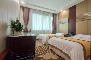 A hotel room with two beds, a desk, a chair, a potted plant, and a large window with curtains. - Guangyun Hotel Beijing (Beijing)