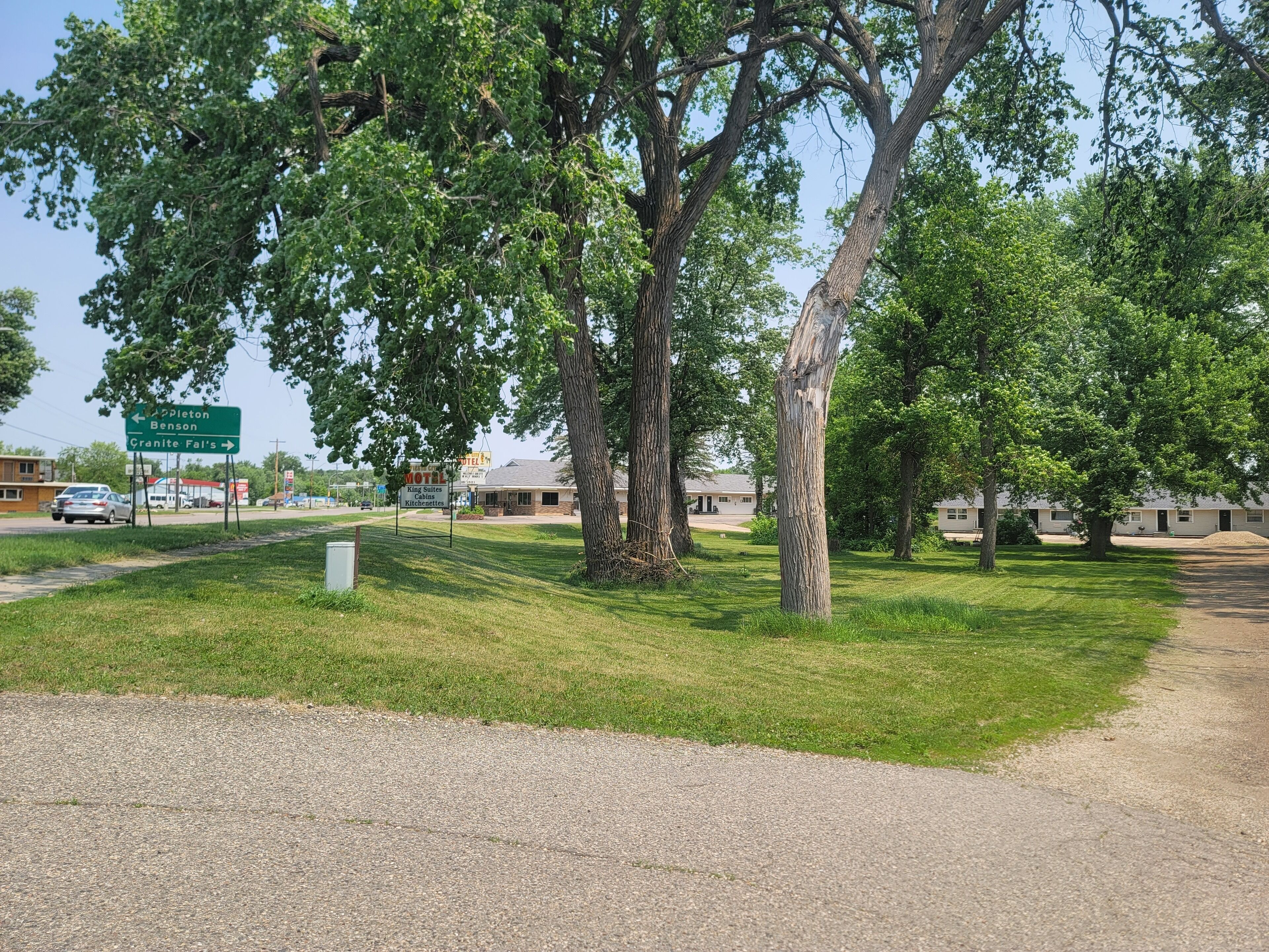 A motel with a signboard indicating directions to nearby locations.