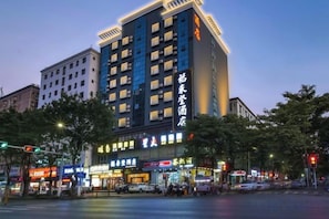 A multi-story hotel with illuminated signage, located at a city intersection. - Fulaideng Hotel (SHENZHEN)