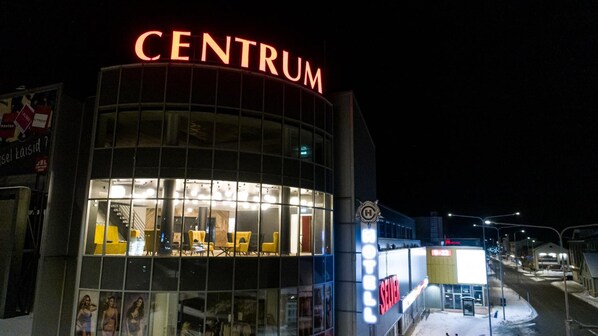 A building with a prominent 'CENTRUM' sign, large windows, and a modern architectural design.