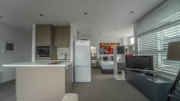 Studio Style Apartment With Balcony | Living area | Flat-screen TV