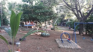 An outdoor playground with a swing set, tire swings, and a small slide. - Hermosa Quinta en Costa Pájaros (Manzanillo)