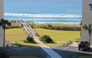 A view of the ocean from a parking lot with a wooden boardwalk leading to the beach. - Spacious Destin Condo with Beautiful Ocean Views, Free Seasonal Beach Setup (Destin)