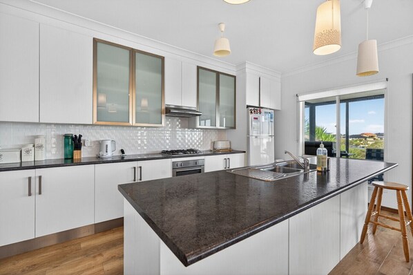 A modern kitchen with a large island, stainless steel appliances, and a view of the outdoors. - 35 Blanche Parade, Hindmarsh Island (Hindmarsh Island)