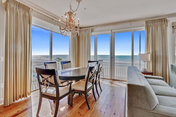 Relax in this serene space with a large dining table, comfortable sofa, and ocean views.