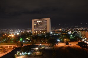A high-rise hotel with multiple floors and a central courtyard. - Royal Suites New Kingston (Kingston)
