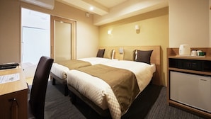 A hotel room with two beds, a desk, a chair, a mini-fridge, and a microwave.
