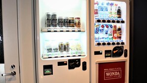 Two vending machines with beverages and snacks, one labeled 'WONDA'.
