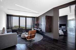 A modern living room with a large window, dark wood flooring, and contemporary furniture. - Shenzhen O Hotel (Shenzhen)