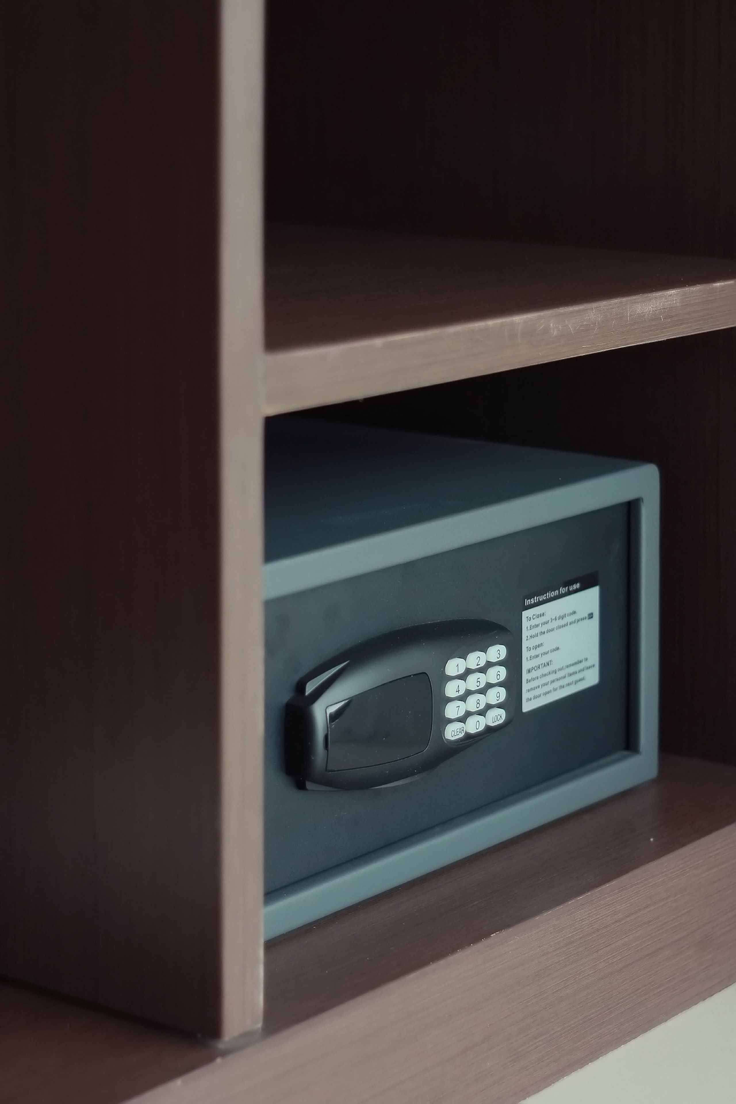 A microwave in a cabinet with a label.
