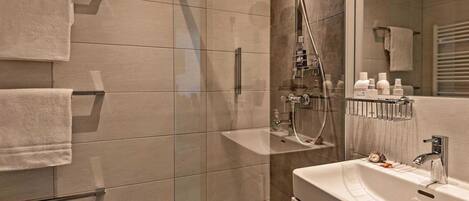 Shower, hair dryer, towels, toilet paper