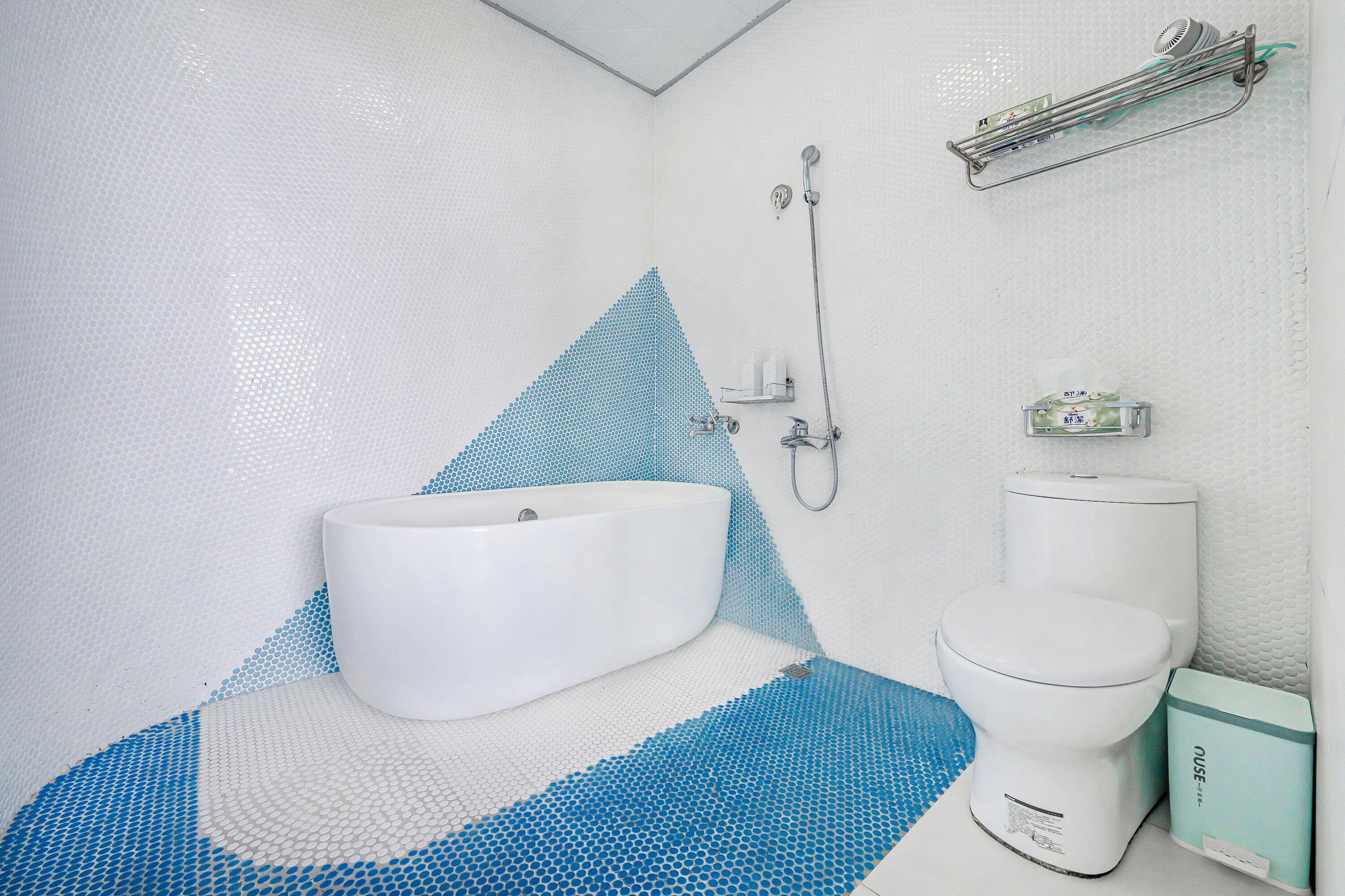 A bathroom with a white sink, toilet, and shower.