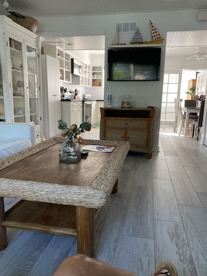 Relax in this inviting space with a large coffee table, TV, and cozy bench.