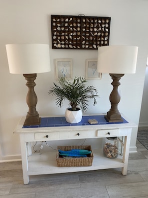 Enjoy a peaceful workspace with a central desk, decorative wall panel, and a touch of greenery.