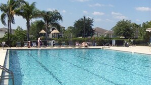 A rectangular swimming pool with clear blue water, surrounded by lounge chairs and palm trees. - 2 Bed 2 Bath First Floor Condo in Stoneybrook of Estero Golf Community  (Estero)