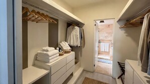 A walk-in closet with hanging space and a vanity area. - New Modern Condo, Private Pool, close to the Malecon & Marina Cortez La Paz BCS (La Paz, B.C.S.)