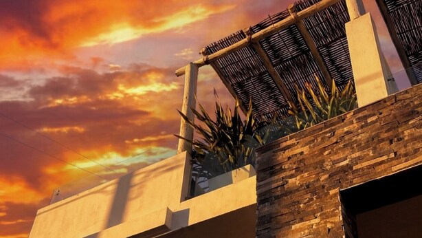 A modern building with a flat roof, a stone facade, and a large overhang. - New Modern Condo, Private Pool, close to the Malecon & Marina Cortez La Paz BCS (La Paz, B.C.S.)