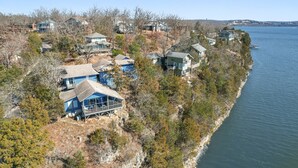 A coastal residential area with houses built on a cliff overlooking a body of water. - Margaritaville Resort~ Close to the Pool~ Large Home-Amazing Water Views-Recently Redecorated (Osage Beach)