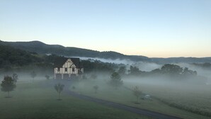 A large house with a driveway and a small shed in a foggy rural setting. - Weekend getaway short distance from DC/Northern Virginia (Markham)