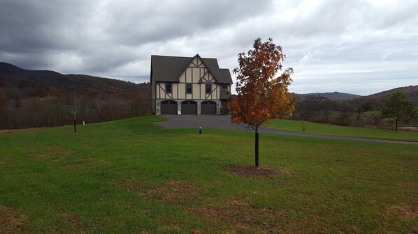 A large, two-story building with a gabled roof and a stone foundation, surrounded by a grassy field and trees. - Weekend getaway short distance from DC/Northern Virginia (Markham)