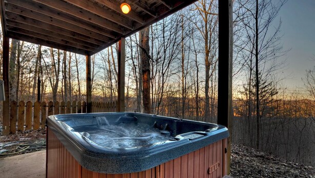 A wooden hot tub with a view of a forested area. - Dancing Bears | Hot Tub | Grill (Morganton)
