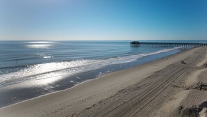 A beach with a pier extending into the ocean, sandy shore, and clear skies. - Surfmaster - Oceanfront 3 Bedroom/3 Bath  Beautiful!!! Great Rates!! (Garden City)