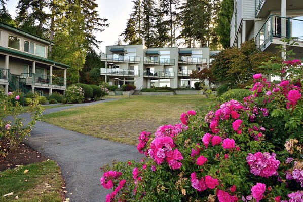 A multi-story residential building with a covered outdoor area and a pathway leading to it.