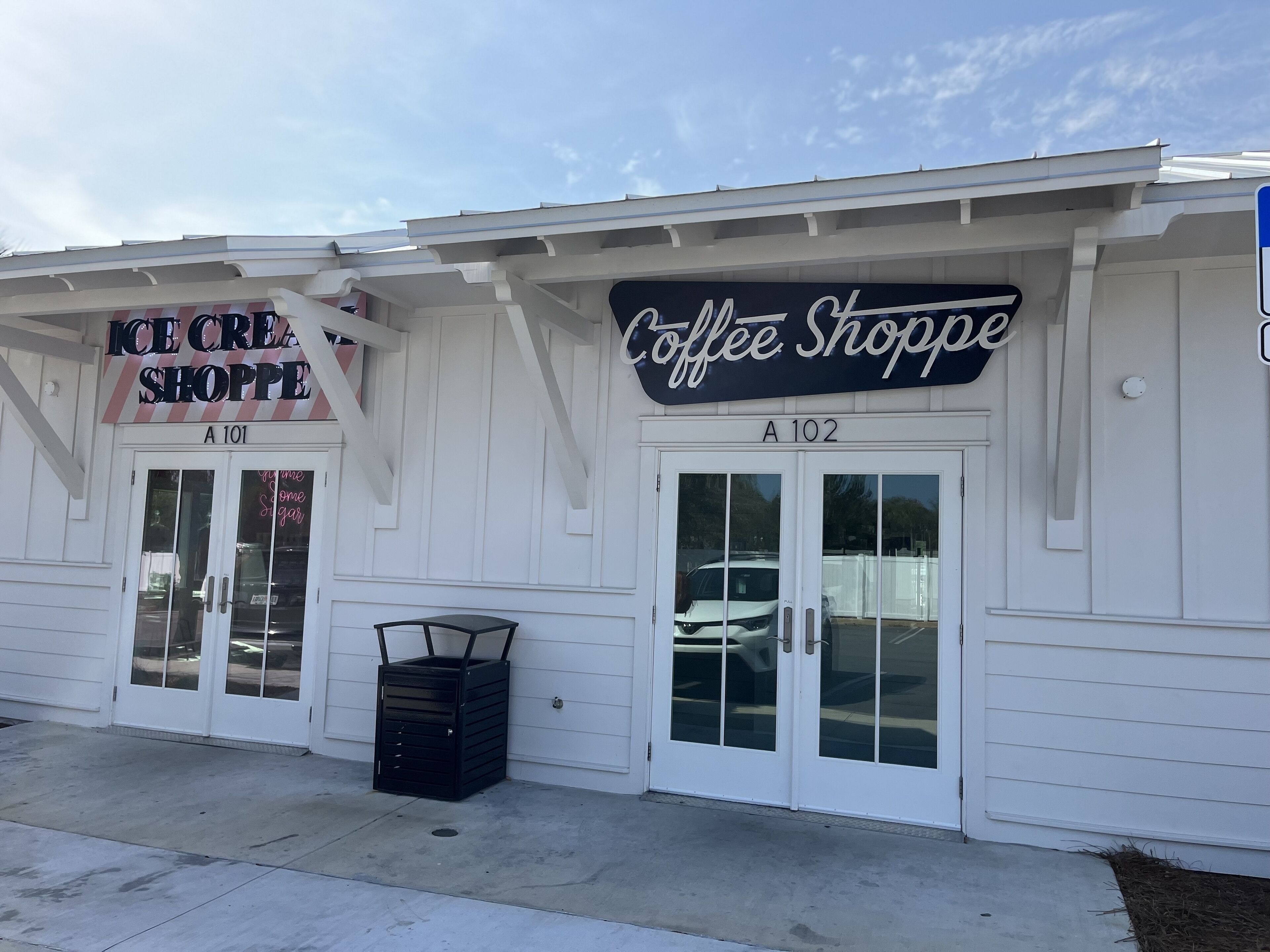 A building with two storefronts, one labeled 'Ice Cream Shoppe' and the other 'Coffee Shoppe'.